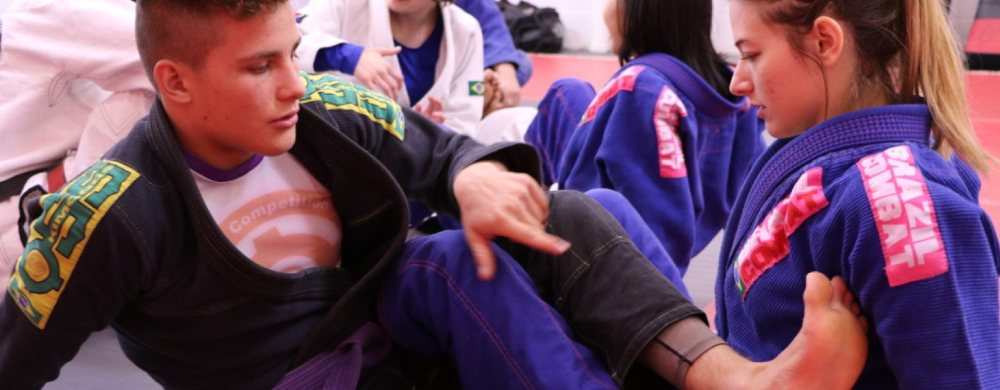 Adult Brazilian Jiu-Jitsu class rolling in the gi at Baltimore Martial Arts Academy in Catonsville, MD