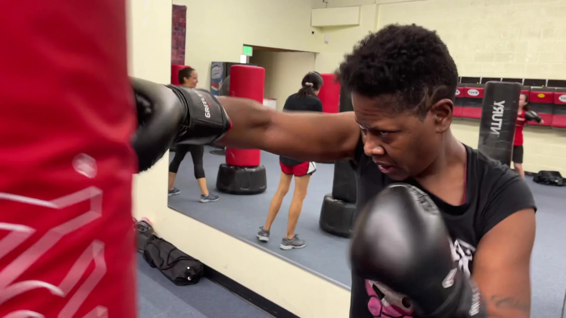 Member driving a straight punch into a heavy bag at Baltimore Martial Arts Academy