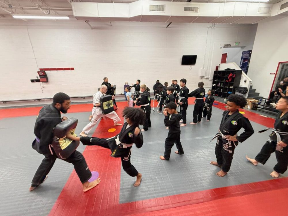 Kids Karate and Tae Kwon Do class kicking pads with instructors at Baltimore Martial Arts Academy
