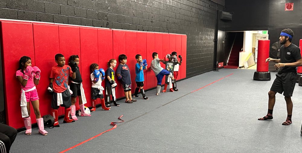 Coach Deon Jackson leading a kids Muay Thai class at Baltimore Martial Arts Academy in Catonsville