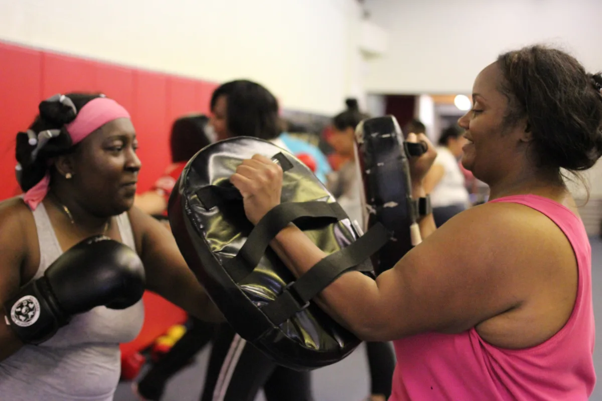Two women working kickboxing mitt drills at Baltimore Martial Arts Academy